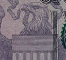 On the $5 bill note the repeating 'E PLURIBUS UNUM' across the top of the eagle's shield and the 'USA' at the top of each white stirpe.