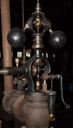 The governor of the main steam engine.  It regulated and maintained a constant rpm of the main engine and thus the belt drive.