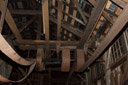Pulleys and belts on a side shaft. Note that the pulley on  the left at least appears to be made of wood.