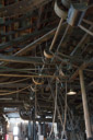 A view of the belts on the main and slave drive shafts. This is probably only a fraction of those in full operation. Note that most are slack and many pulleys have no belts attached.