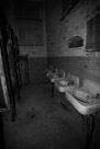 The sinks across from the toilet stalls. I think the black and white treatment captures the instutional feel of the place.