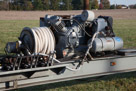 This is the compressor and hydraulic unit. The day I watched the cannon in operation he used a rented compressor to pressurize the air tank because it was faster.  The on-board compressor is for when no rental is locally available.  You can see the handles used to operate the hydraulic valves that operate the various functions - elevate the gun barrel, open and close the breach, pop the firing valves.