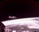 Agena docking vehicle and earth as seen from the Gemini VIII capsule.