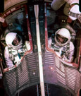 Astronauts Gordon Cooper Jr. and Pete Conrad Jr. in the Gemini V space capsule prior to launch.  May have been the only two 'Jr's flew together.