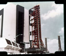 Saturn V rollout Kennedy Space Center. Two mobile launchers in the background. The slide does not provide enough information to determine which vehicle this is.