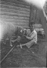 Age 8 years, 2 months, 19 days.
August 8, 1950. 
Lamb is Roy. Note bell on Roy.  This is taken at the back door to the Ellis Place.