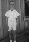 aged 6 years, 1 month, 1 day.
June 20, 1948.
At side of house at Johnson Place. On the way to church I suppose.