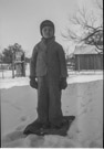 Aged 6 years, 8 months, 12 days.
January 31, 1949.
We are at the Johnson Place. Note the garage at the right and the windmill in the background. I played a lot at the windmill. Mud and all.