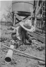 Aged 4 years, 11 months.
April 19, 1947
There was a windmill just east of the pens at the Johnson Place. This was one of my absolute favorite places to play. I made irrigation canals and ran water in little fields. Build dams. Drown ant lions. And ants. And that walking cane in the foreground. I used it all the time. Didn't need a cane to walk at all. Just saw people using canes, thought it was cool  walked around with it. Good for poking thickets and scaring up wildlife.