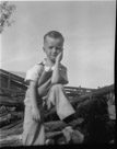 Aged 4 years, 5 months.
October 19, 1946.
On a pile of cedar posts. Roy Spinks was upgrading the fences at the Johnson Place and got so cedar posts for down around Junction. The fresh cedar really smelled good.