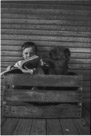 Aged 5 years, 2 months.
July 19, 1947
Dog is Suppie.
We liked to read in the box. All cozy. Probably looking at a Sears catalog.