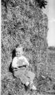 Aged 19 months.
December 19, 1943. 
The day I got my second Christmas tree. But mom took the picture at a hay stack. (Where I loved to play)