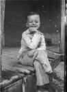 Aged 5 years, 7 months, 1 day.
December 20, 1947.
The bright spots in the background are light coming through holes in the porch roof.