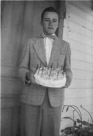 Aged 15 years.
May 19, 1957.
In front of the house in town.  One of mom's cactus plants in the lower background.