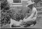 Aged 15 years, 2 months.
July 19, 1957.
Don't know the name of the goat. Little angora. In the background you can see where we are building the shed behind the house and in the distance the outhouse.