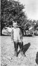 Aged 3 years, 7 months.
December 19, 1945. 
In dads boots. Note the pens and shed in the background. The shed is where the chickens and turkeys stayed. This is at the Johnson Place.