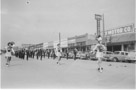 Aged 15 years, 5 months.
October 19, 1957.
Gwen Bean is the drum major. Susan Mears is behind her. Note the businesses on main street. We had 2 car dealerships in town then. Moser's  is shown here with lots of Chevrolets out front.