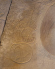 Small shields. Note the arrow(spear?) through the top one. And the long fringed tail going up for same.