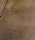 A fringed shield with two zoomorphs. Note the anthromorph at the upper left of the shield. Man with big hands. Line down the center may be a symetry mark. Zoomorphs look a lot like pronghorn antelope but may represent elk.