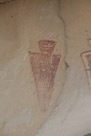 A close up of the left of the two figures under the overhang in the corral. Note the feather and eye(s). The sheep at the bottom is more visible here.