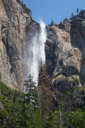 Bridal vail falls. Wind coming up the valley gets under and behind the waterfall to give it the floating birdal vail effect. Took many pictures of this.  Used a polarizing filter to cancel the glare off the wet granite. Gives a nice contraxting black background.